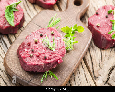 Piece of beef tenderloin on the wooden cutting board. Stock Photo
