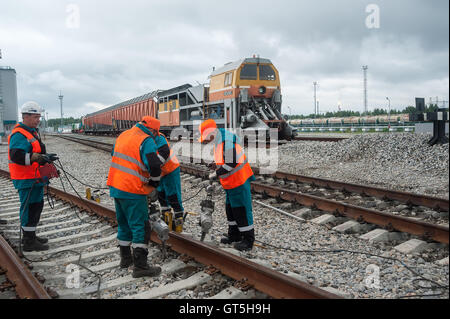 Railway workers repairing rail Stock Photo