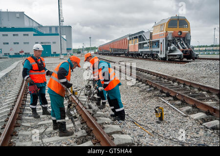 Railway workers repairing rail in rain Stock Photo