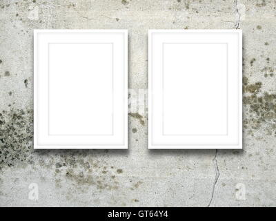 Close-up of two blank picture frames on gray cracked concrete wall background Stock Photo