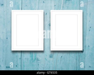 Close-up of two blank picture frames on aqua weathered wooden boards background Stock Photo