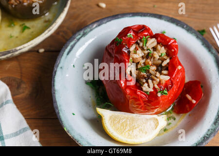 Red peppers stuffed with rice and vegetables Stock Photo