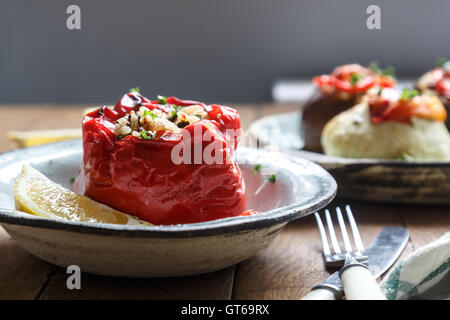 Baked red pepper stuffed with rice, peanuts and prunes. Traditional Greek Gemista. Rystic style Stock Photo