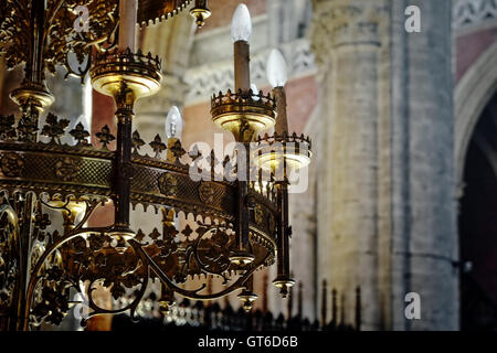 Decorated chandelier in St. Michiels church in Ghent, Belgium, on July 19, 2016 colored with sun beams from stained glass window Stock Photo