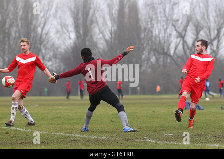 Shakespeare (red) vs MDM United - Hackney & Leyton Sunday League Football at South Marsh, Hackney Marshes, London - 15/02/15 Stock Photo