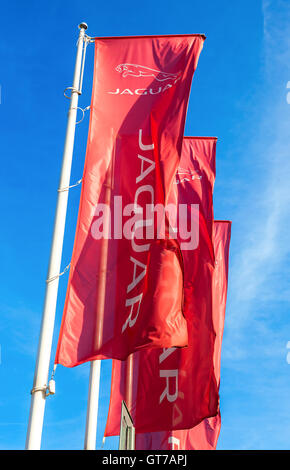 Official dealership flags of Jaguar against the blue sky background Stock Photo