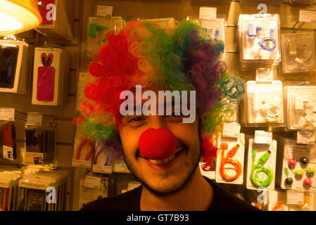 young man with fright wig and red nose head gear Stock Photo