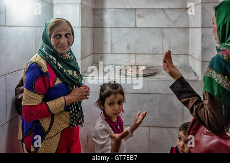 Shenananou Kanjani worships before the Atash Bahram, meaning “Victorious Fire”, dated to 470 AD  with Zoroastrian symbols. Stock Photo