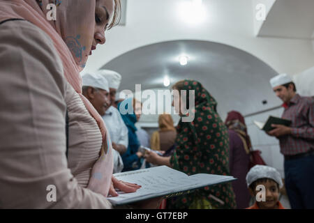 Worshippers before the Atash Bahram, meaning “Victorious Fire”, dated to 470 AD  with Zoroastrian symbols. Stock Photo