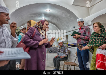 worshippers before the Atash Bahram, meaning “Victorious Fire”, dated to 470 AD  with Zoroastrian symbols and offerings of cookies. Stock Photo