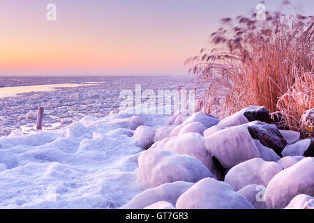Sunrise over a frozen lake Marken in The Netherlands. Stock Photo