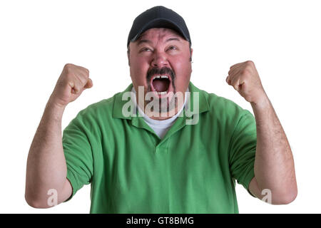 Excited Overweight Man Wearing Green Shirt and Black Baseball Cap Celebrating, Pumping Fists and Cheering in Studio with White B Stock Photo