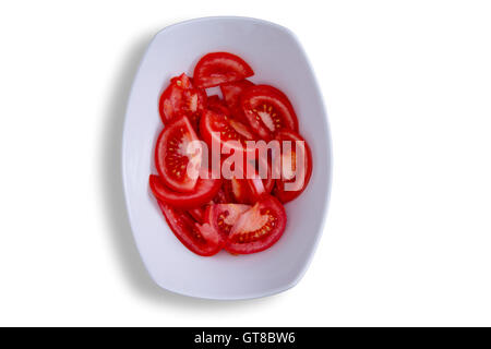 Close up Thin Sliced of Healthy Red Tomatoes on White Bowl, Isolated on White Background. Captured in High Angle View. Stock Photo