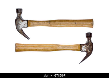 Two old rusty claw hammers arranged facing in opposite directions conceptual of equal power isolated on a white background Stock Photo