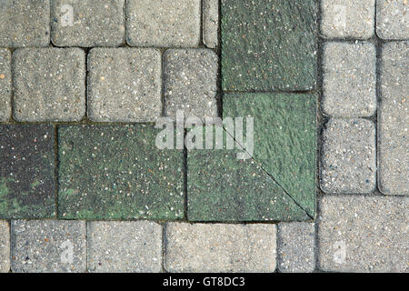 Overhead view of the corner pattern in ornamental grey brick paving on an outdoor patio or garden landscaping Stock Photo