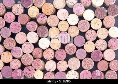 Old wine corks arranged in a background pattern viewed from above with both red and white wine represented in a random scatter, Stock Photo