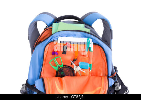 Orange and blue kids school backpack packed with a tablet, notebooks, scissors, pens, books, and stationery ready for a creative Stock Photo