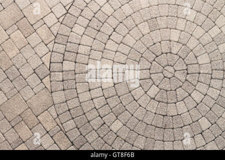 Paver bricks arranged in a circular pattern of concentric geometric circles. Architectural background of an ornamental pattern i Stock Photo