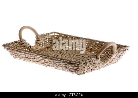 Rustic rectangular wicker tray with curved wooden handles made with willow canes for serving beverages and food, low angle isola Stock Photo