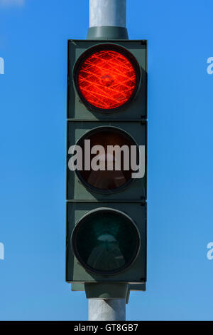 Red Traffic Light Against Blue Sky, Denmark Stock Photo