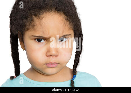 Close up Young Girl Staring at You with Angry Facial Expression Against White Background. Stock Photo