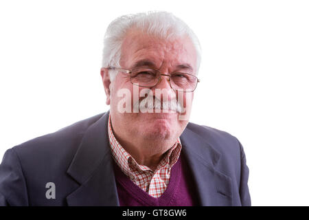 Dissatisfied distinguished white-haired senior man grimacing in disapproval as he looks at the camera, head and shoulders isolat Stock Photo