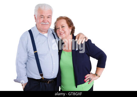 Married senior husband and wife standing together in harmony looking at camera over white background Stock Photo