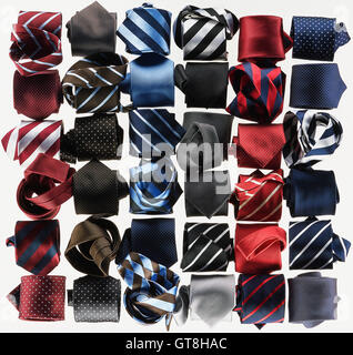 Group of necktie roled-up on white background Stock Photo