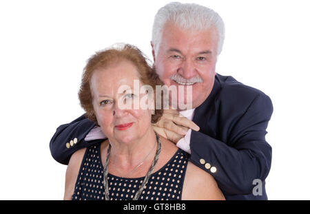 High angle view of cheerful husband in blue suit leaning slightly on back of his grinning wife over white background Stock Photo