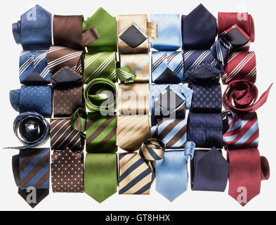 Group of multi coloured neckties roled-up on white background Stock Photo