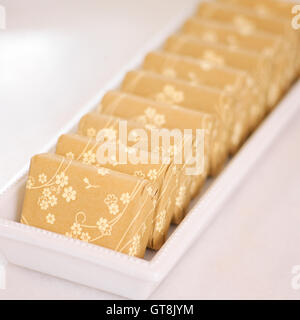 Close-up of Floral Wrapped Bars of Soap in Dish Stock Photo