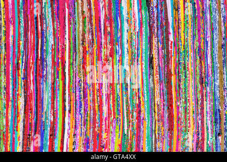 Close up colorful hand woven rug with red, blue, yellow, purple and other colors as background Stock Photo