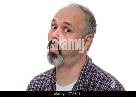 Surprised middle-aged man in his pyjamas in the early morning looking sideways at the camera with an expression of incredulous a Stock Photo
