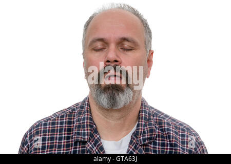 Sleepy man with beard and plaid shirt snores with his eyes closed against a white background Stock Photo