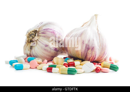 Pills and garlic isolated on white background. Natural antibiotics. Stock Photo