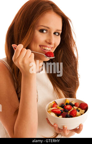 healthy eating  - woman eats a bowl of fruit salad isolated over white background - vegetarian meal Stock Photo