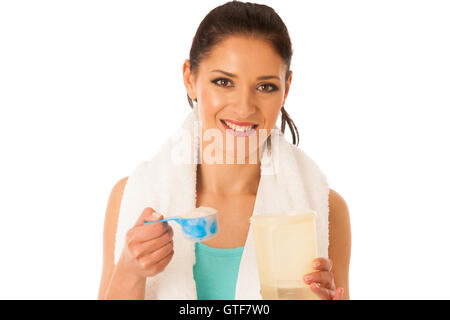 Woman preparing protein shake after fitness workout in gym isolated over white background Stock Photo