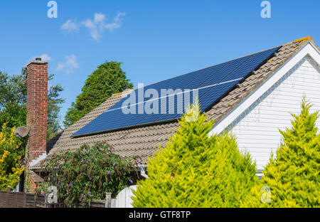 Solar panels on the roof of a bungalow in the UK. Stock Photo