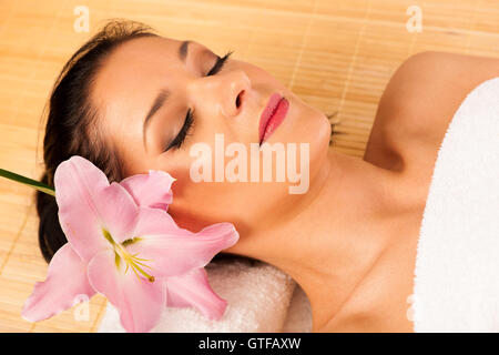 Beautiful young woman having a face massage in wellness studio - spa Stock Photo