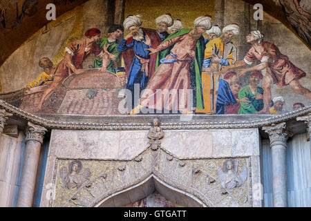 Mosaic on the facade of st Marks basilica with scenes showing the history of the relics of Saint Mark, Venice Italy Stock Photo