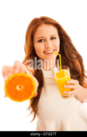 Woman drinking orange juice smiling showing oranges. Young beautiful  Caucasian model. Stock Photo