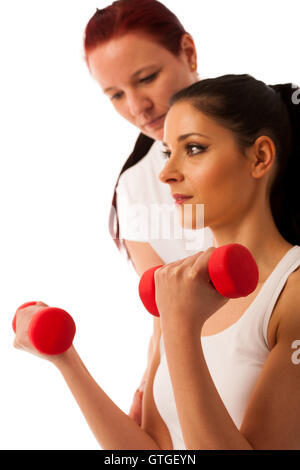 Physiotherapy - therapist doing arm  excercises with dumbbells for improving arm strenght and coordination  with a patient to re Stock Photo