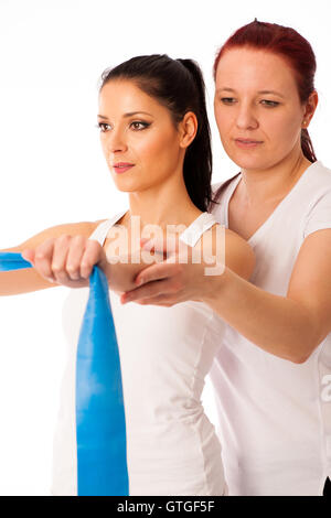 Physiotherapy - therapist doing arm strenghteninh excercises with a patient to recover strenght after injury Stock Photo