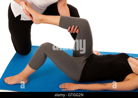Physiotherapy - therapist doing   leg stretching excercises with a patient to recover  after injury isolated Stock Photo
