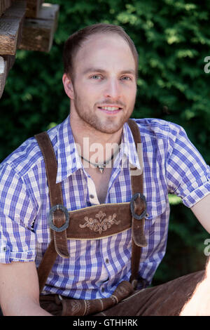 portrait of handsome young man outdoors in traditional bavarian clothes Stock Photo