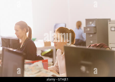Focused businesswomen working at computers in office Stock Photo