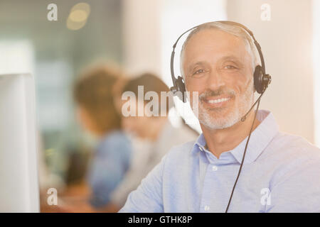 Portrait smiling businessman with headset in office Stock Photo