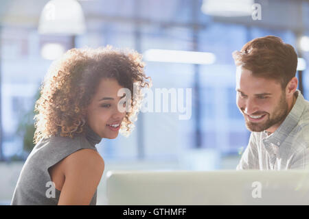 Businessman and businesswoman working at computer in office Stock Photo