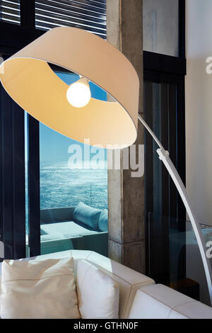 Arc sectional lamp in luxury living room with ocean view Stock Photo