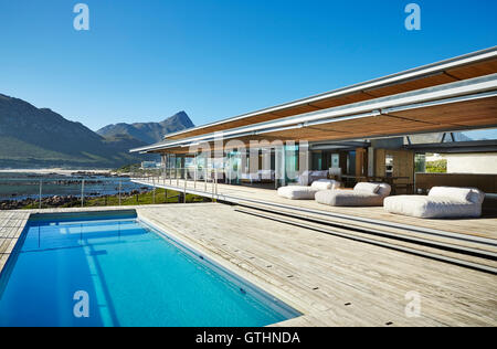Modern luxury hotel swimming pool under sunny blue sky Stock Photo